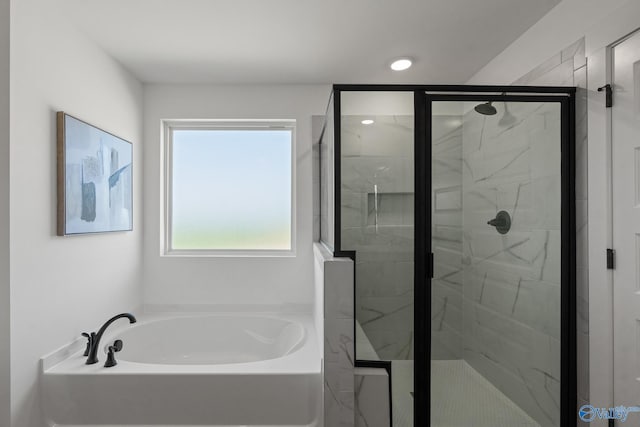 bathroom featuring shower with separate bathtub