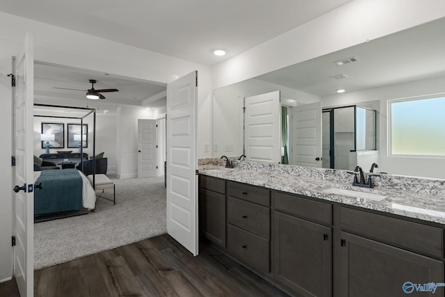 bathroom featuring wood-type flooring, an enclosed shower, ceiling fan, and vanity