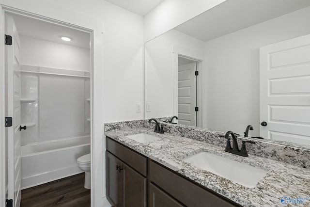 full bathroom featuring vanity, wood-type flooring, bathing tub / shower combination, and toilet