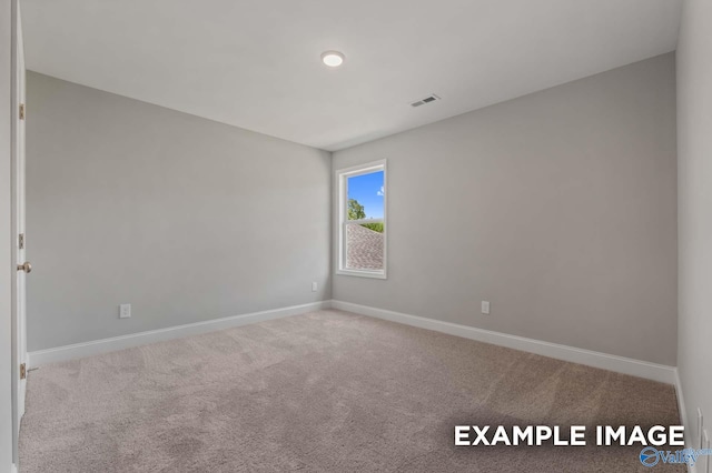 unfurnished room featuring light carpet