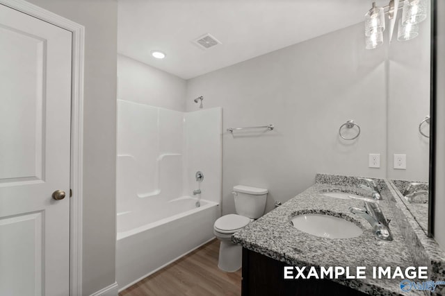 full bathroom featuring vanity, wood-type flooring, shower / bathtub combination, and toilet