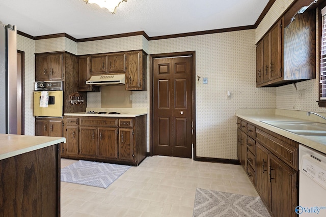 708 Apache St NW, Hartselle, AL 35640 - kitchen with white appliances, extractor fan, ornamental molding, light countertops, and wallpapered walls