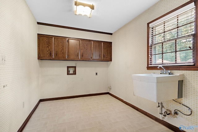 708 Apache St NW, Hartselle, AL 35640 - washroom with cabinet space, wallpapered walls, electric dryer hookup, hookup for a washing machine, and baseboards