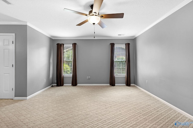 708 Apache St NW, Hartselle, AL 35640 - spare room with a ceiling fan, light colored carpet, baseboards, ornamental molding, and a textured ceiling