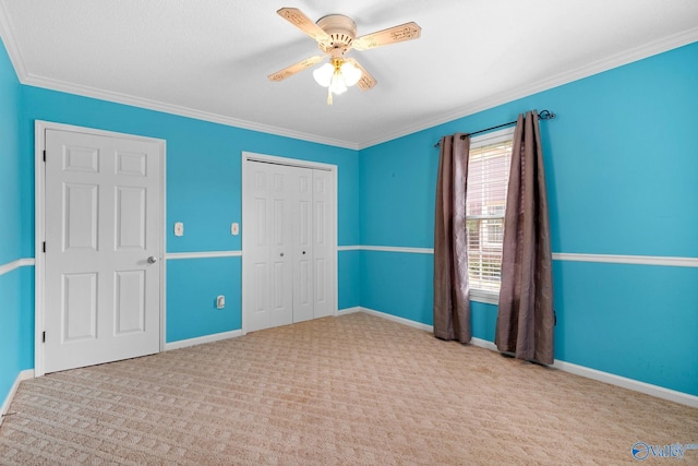 708 Apache St NW, Hartselle, AL 35640 - unfurnished bedroom with a closet, carpet floors, crown molding, and baseboards