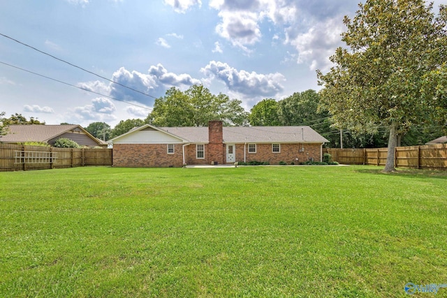 708 Apache St NW, Hartselle, AL 35640 - back of property with brick siding, a chimney, and a patio
