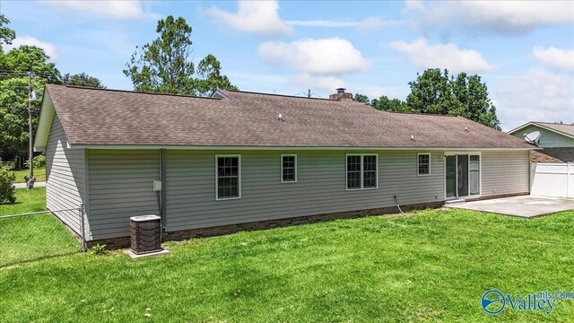 304 Ohara Dr, Albertville, AL 35950 - back of house featuring a shingled roof, a patio area, a chimney, and central air condition unit