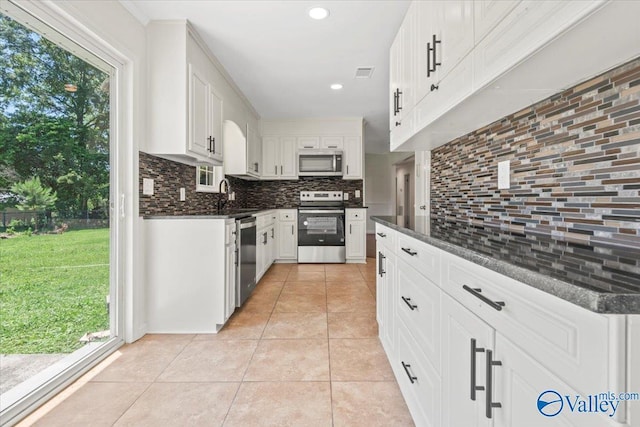 304 Ohara Dr, Albertville, AL 35950 - kitchen featuring appliances with stainless steel finishes, decorative backsplash, light tile patterned floors, healthy amount of natural light, and recessed lighting