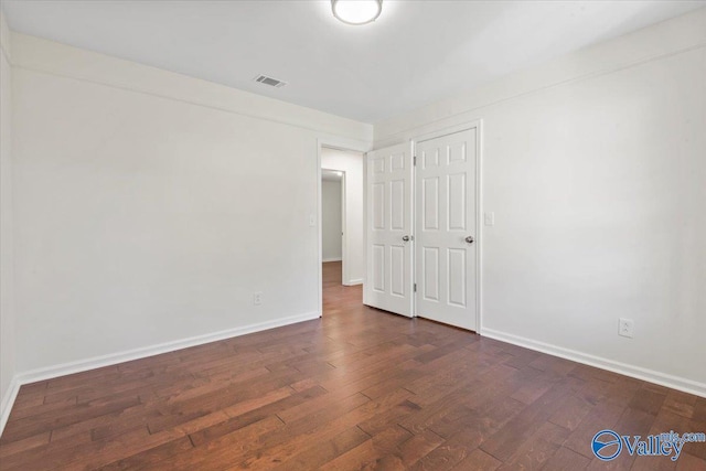 304 Ohara Dr, Albertville, AL 35950 - spare room featuring dark wood-type flooring and baseboards
