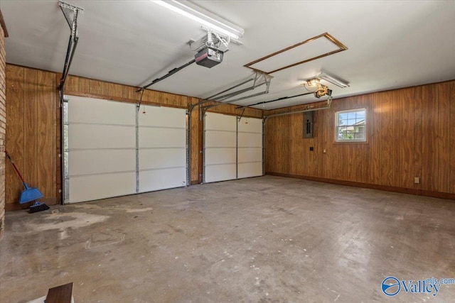 304 Ohara Dr, Albertville, AL 35950 - garage with electric panel, wood walls, and a garage door opener