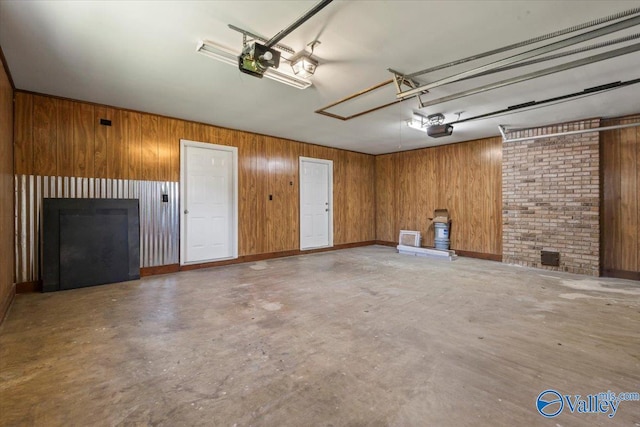304 Ohara Dr, Albertville, AL 35950 - garage featuring wooden walls and a garage door opener