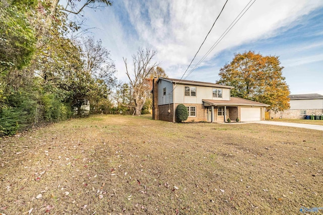 view of front of property with a garage and a front lawn