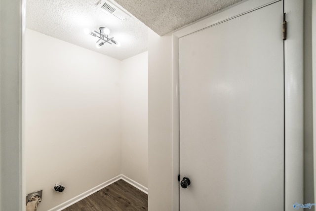 washroom with hardwood / wood-style flooring and a textured ceiling