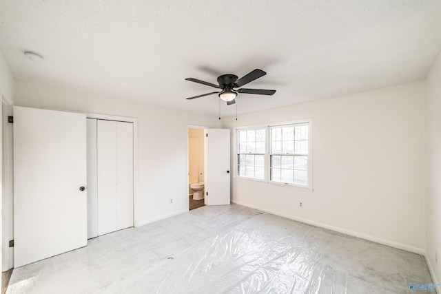 unfurnished bedroom featuring connected bathroom, ceiling fan, and a textured ceiling