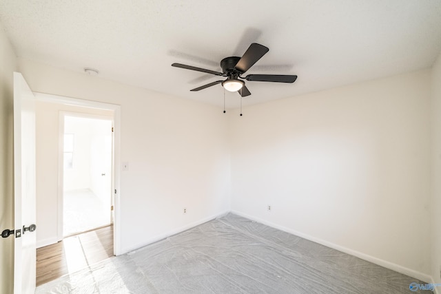 unfurnished room with light colored carpet and ceiling fan