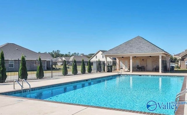 view of swimming pool with ceiling fan and a patio area