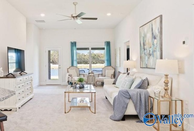 living room with ceiling fan and light colored carpet