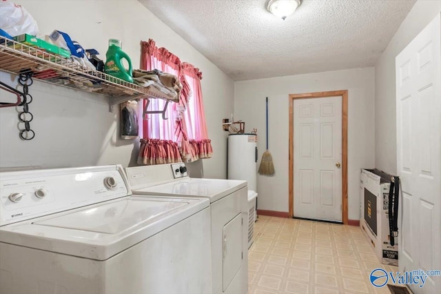 washroom featuring separate washer and dryer, electric water heater, heating unit, and a textured ceiling