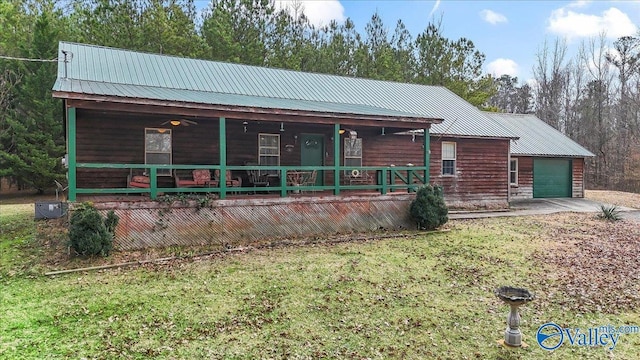 view of front facade with a garage, a front lawn, and a porch