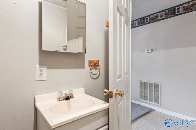 bathroom with vanity and a textured ceiling