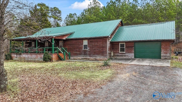 cabin with a garage and covered porch