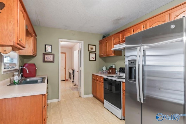 kitchen featuring sink, stainless steel fridge, white electric stove, and a textured ceiling