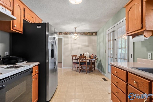 kitchen with range with electric cooktop, an inviting chandelier, a textured ceiling, and decorative light fixtures