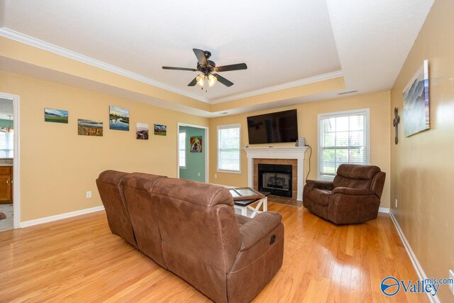 27586 Phillip Wagnon Dr, Athens, AL 35613 - living room with light wood-style floors, ceiling fan, healthy amount of natural light, crown molding, and a tile fireplace