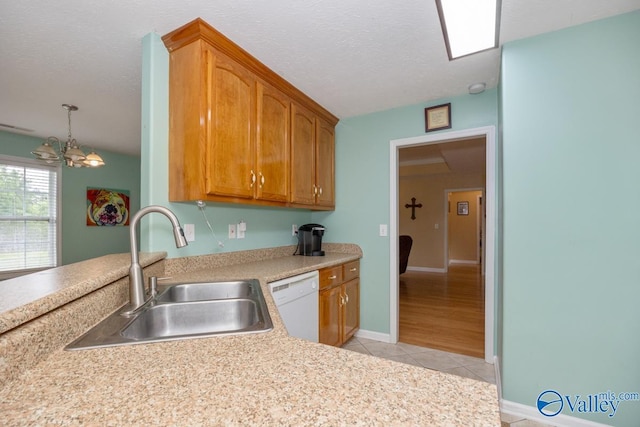 27586 Phillip Wagnon Dr, Athens, AL 35613 - kitchen with white dishwasher, a sink, light tile patterned flooring, a chandelier, and light countertops
