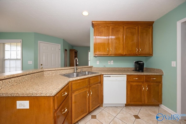 27586 Phillip Wagnon Dr, Athens, AL 35613 - kitchen with dishwasher, a sink, brown cabinets, light tile patterned floors, and a peninsula