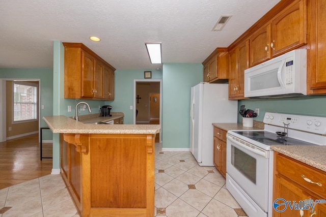 27586 Phillip Wagnon Dr, Athens, AL 35613 - kitchen featuring white appliances, a sink, light tile patterned flooring, light countertops, and a textured ceiling