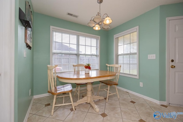 27586 Phillip Wagnon Dr, Athens, AL 35613 - dining area featuring light tile patterned flooring, a chandelier, and baseboards