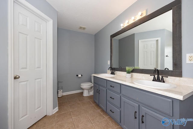 27586 Phillip Wagnon Dr, Athens, AL 35613 - bathroom featuring double vanity, tile patterned floors, baseboards, and toilet