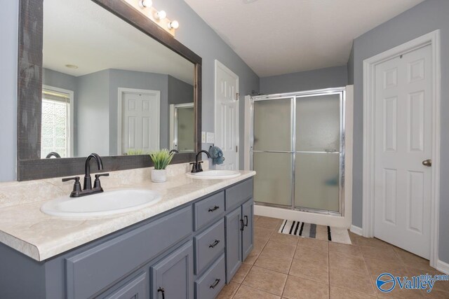 27586 Phillip Wagnon Dr, Athens, AL 35613 - full bathroom with double vanity, a shower stall, and tile patterned floors