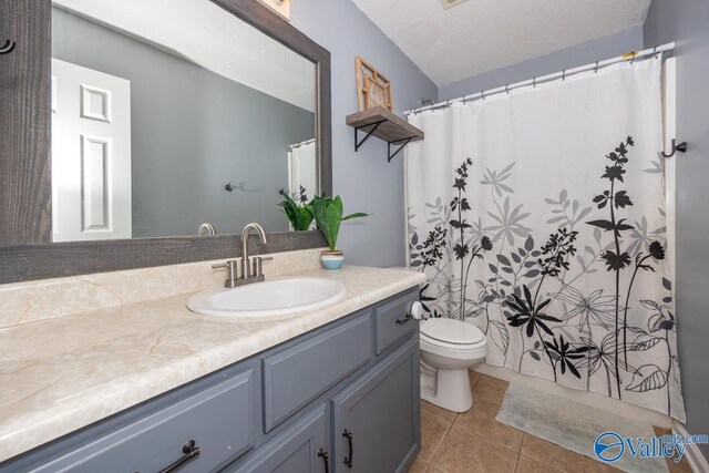 27586 Phillip Wagnon Dr, Athens, AL 35613 - full bath featuring vanity, tile patterned flooring, toilet, and a shower with shower curtain