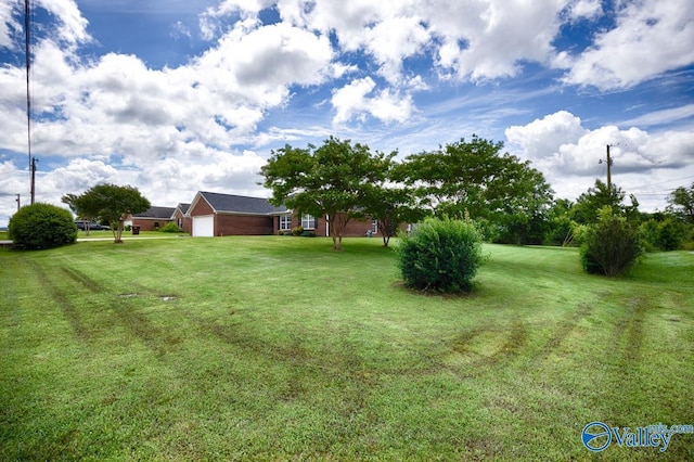 27586 Phillip Wagnon Dr, Athens, AL 35613 - view of green lawn with a garage