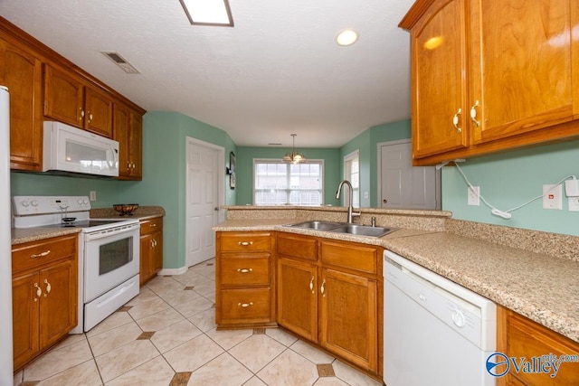 27586 Phillip Wagnon Dr, Athens, AL 35613 - kitchen featuring white appliances, a sink, a peninsula, light countertops, and brown cabinets