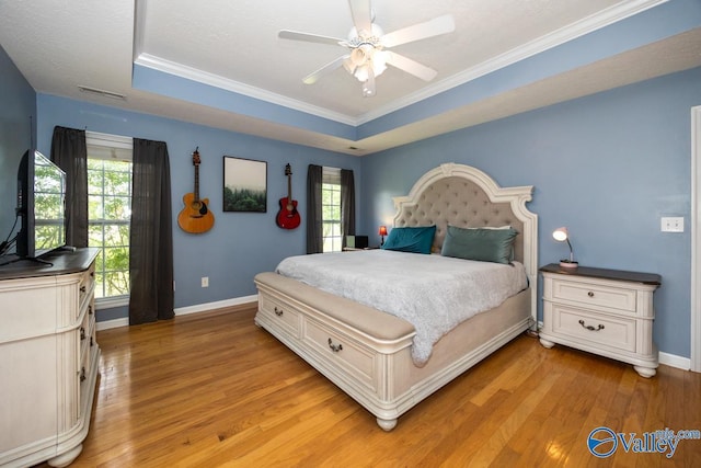27586 Phillip Wagnon Dr, Athens, AL 35613 - bedroom with a tray ceiling, light wood finished floors, baseboards, ornamental molding, and ceiling fan