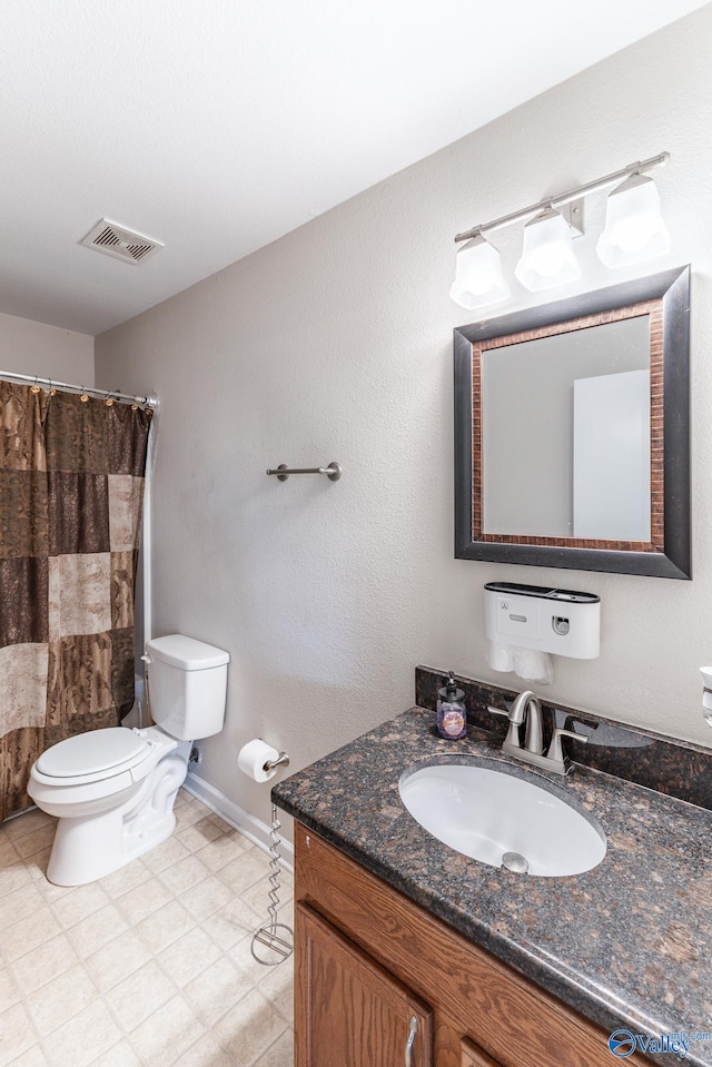 bathroom featuring vanity, toilet, and a shower with shower curtain