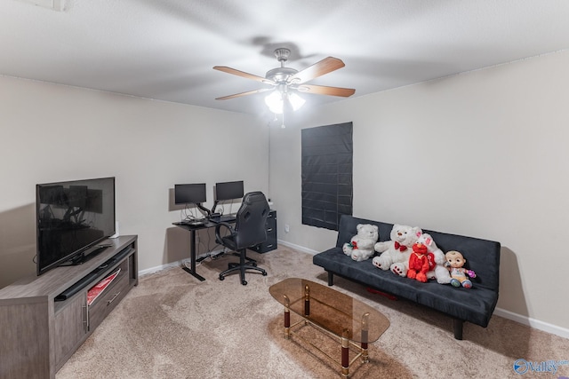 carpeted office featuring ceiling fan