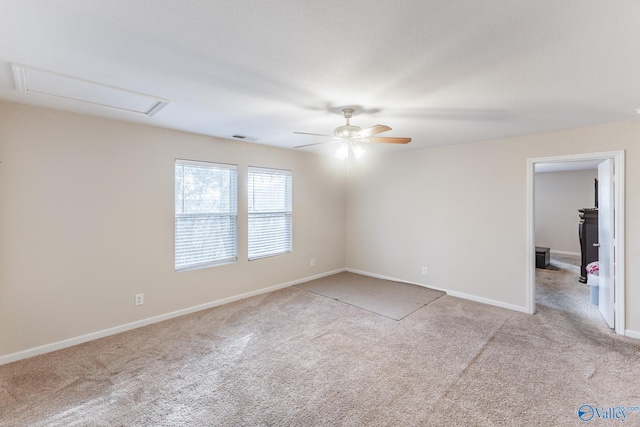 carpeted spare room featuring ceiling fan