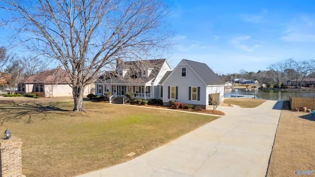 view of front of home featuring a water view, a porch, and a front yard