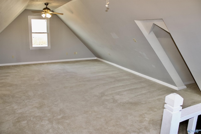 bonus room with ceiling fan, light carpet, and vaulted ceiling