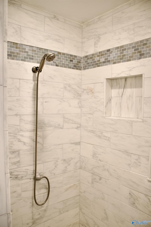 bathroom with a tile shower