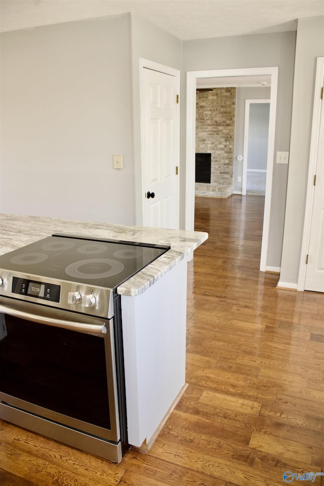 kitchen with wood-type flooring and stainless steel electric range