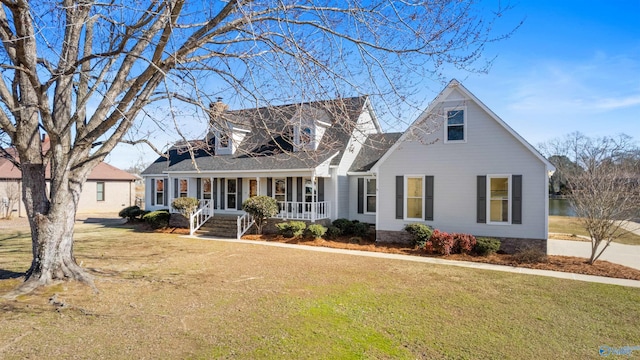 cape cod house featuring a front lawn and a porch