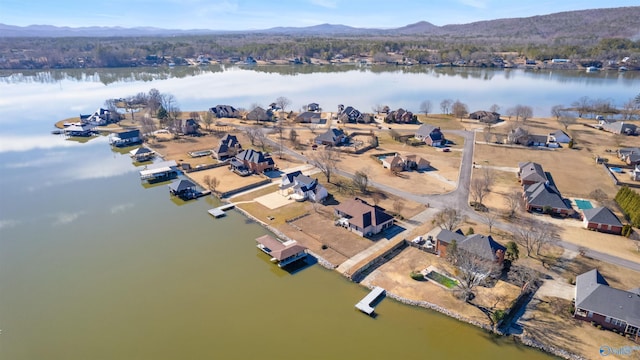 drone / aerial view featuring a water and mountain view