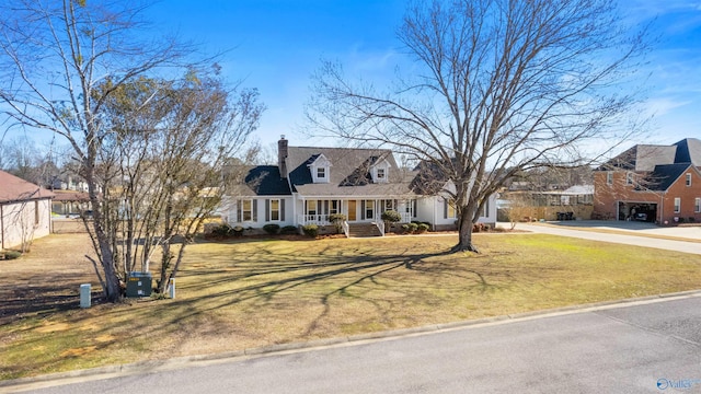 cape cod-style house featuring a front lawn