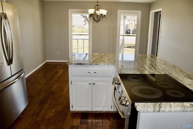 kitchen featuring decorative light fixtures, an inviting chandelier, appliances with stainless steel finishes, white cabinets, and light stone counters