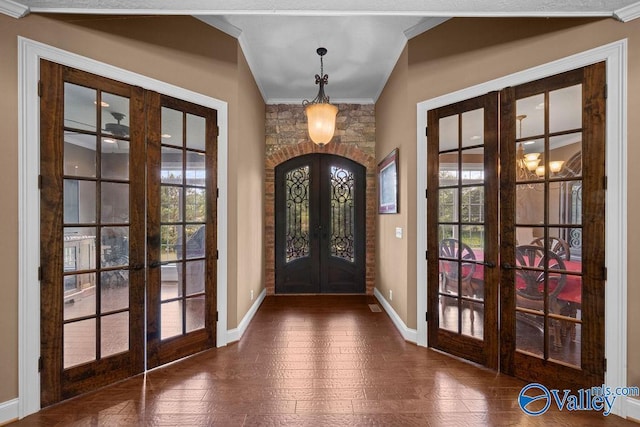 foyer entrance with french doors and ornamental molding